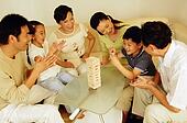 Three generation family in living room, wooden block game on the ... Three generation family in living room, wooden block game on the ...